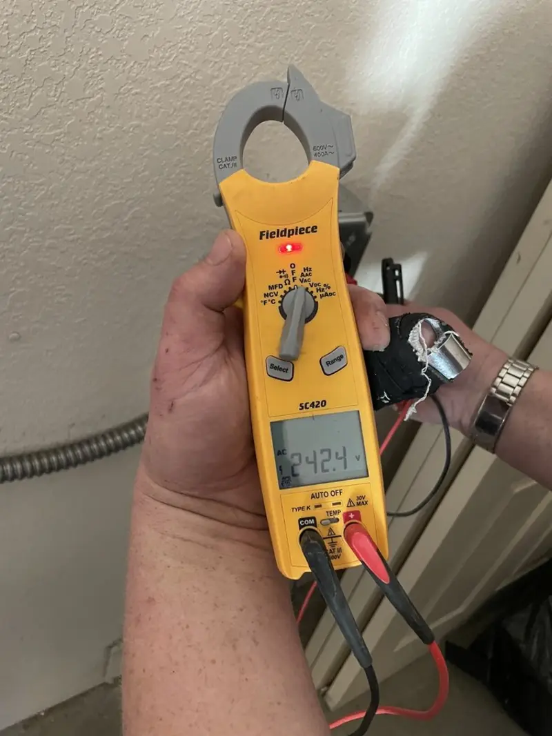 Voltage testing with clamp meter during Electrical Installation Services in Williston